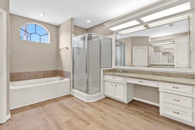 bathroom with vanity, separate shower and tub, and hardwood / wood-style floors