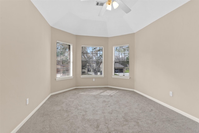 unfurnished room with ceiling fan, vaulted ceiling, a healthy amount of sunlight, and carpet