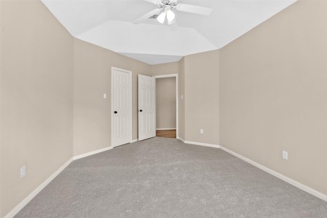 carpeted spare room featuring ceiling fan