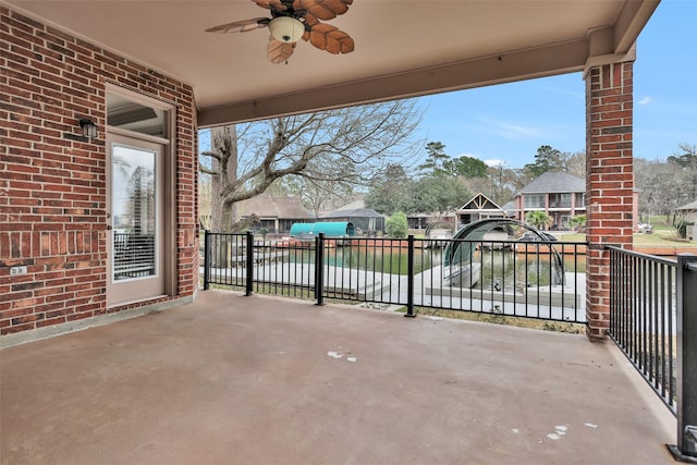 view of patio featuring a water view and ceiling fan