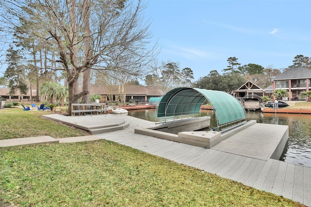 view of dock featuring a lawn and a water view