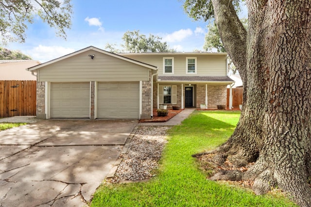 view of property featuring a garage and a front yard