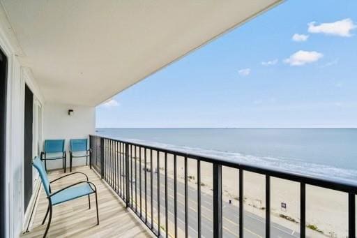 balcony with a view of the beach and a water view