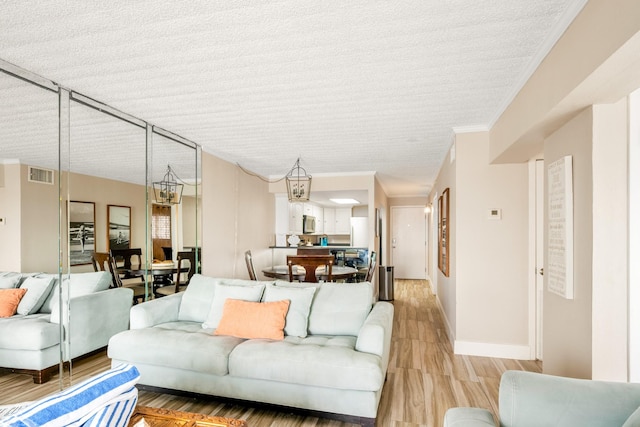 living room with crown molding and light hardwood / wood-style flooring