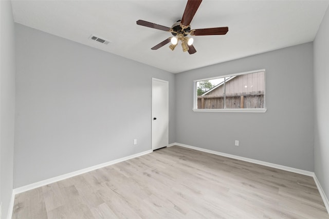 spare room with ceiling fan and light wood-type flooring