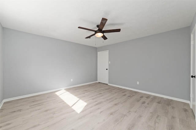 empty room featuring ceiling fan and light wood-type flooring