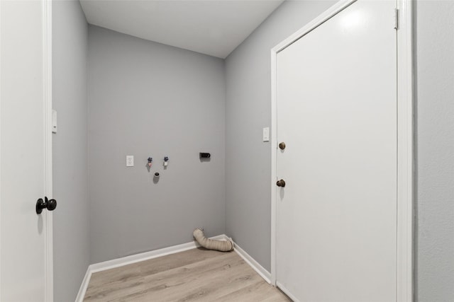 laundry area with electric dryer hookup, hookup for a washing machine, and light wood-type flooring