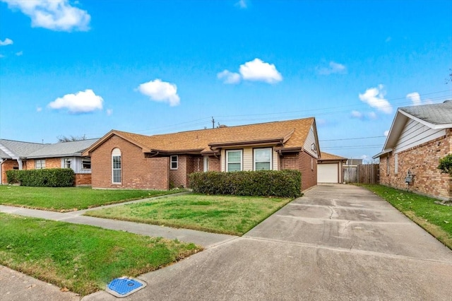 view of front of property featuring a garage and a front lawn