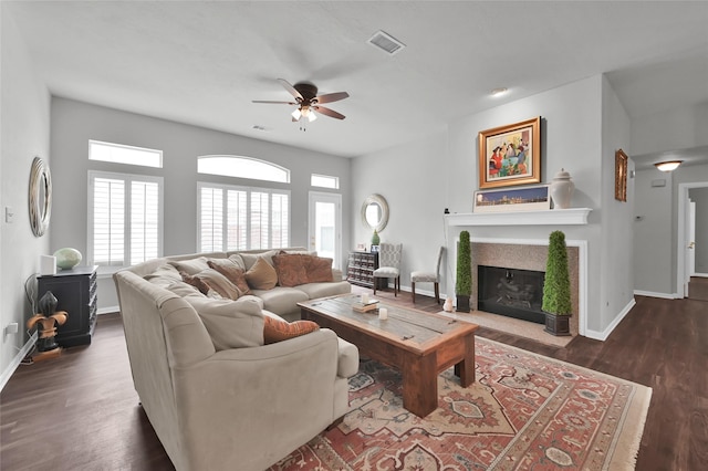 living room with ceiling fan and dark hardwood / wood-style flooring