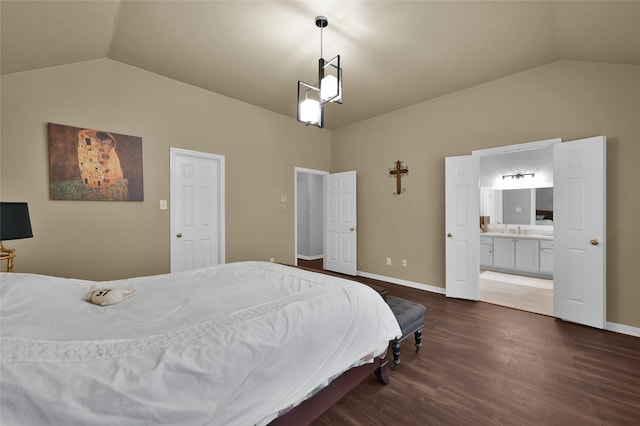 bedroom with ensuite bathroom, lofted ceiling, dark hardwood / wood-style floors, and sink