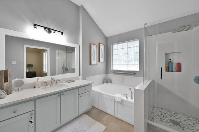 bathroom with vanity, tile patterned flooring, lofted ceiling, and separate shower and tub