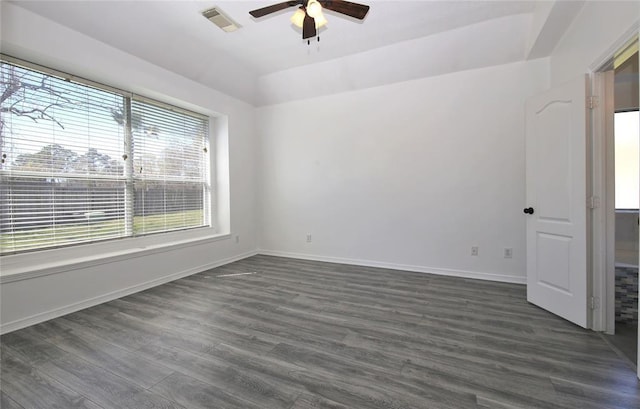 unfurnished room with ceiling fan and dark wood-type flooring