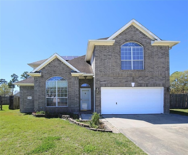 view of front of property with a front yard and a garage