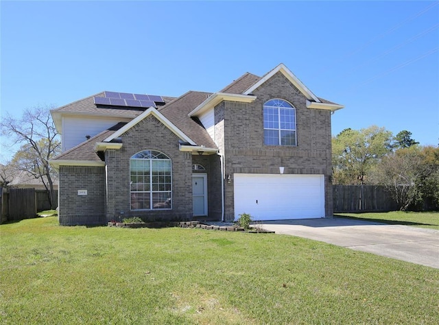 view of front property featuring solar panels, a front yard, and a garage