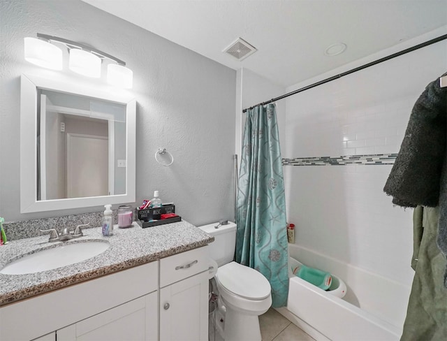 full bathroom featuring vanity, tile patterned floors, toilet, and shower / bath combo with shower curtain