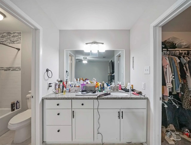 full bathroom featuring washtub / shower combination, vanity, toilet, and tile patterned flooring