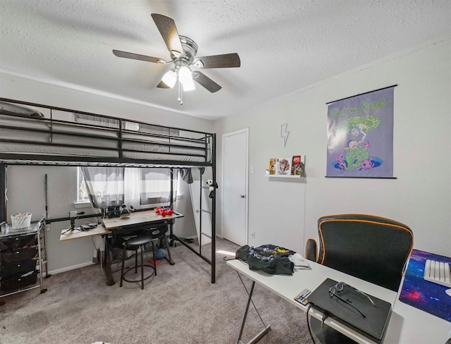 carpeted bedroom with ceiling fan and a textured ceiling