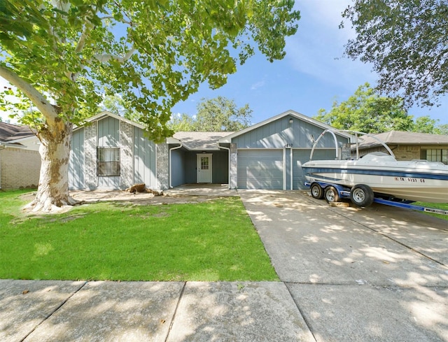 view of front of home with a garage and a front lawn