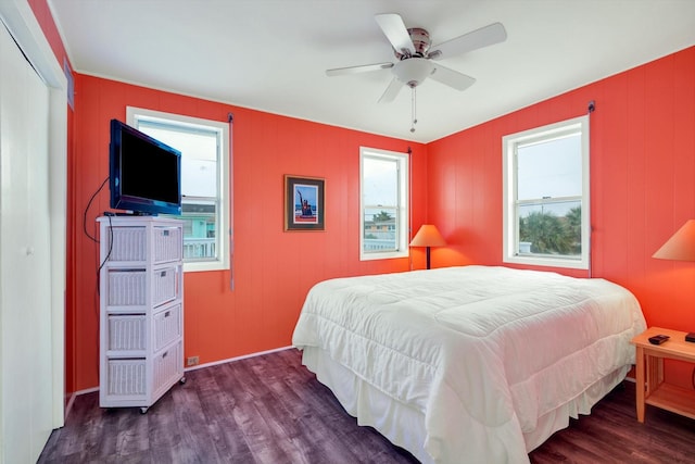 bedroom with ceiling fan and dark hardwood / wood-style flooring