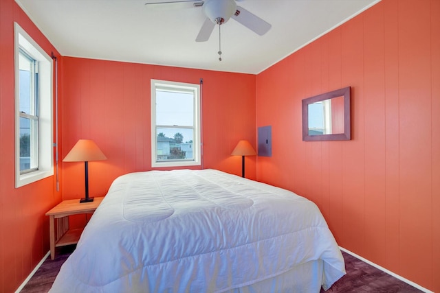 bedroom featuring dark wood-type flooring, electric panel, and ceiling fan