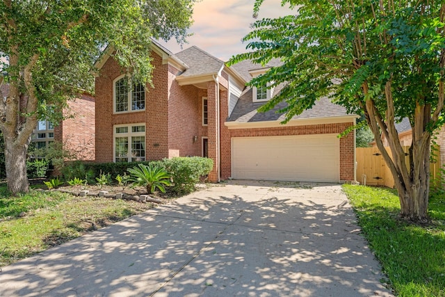 view of front of house with a garage, brick siding, driveway, and roof with shingles