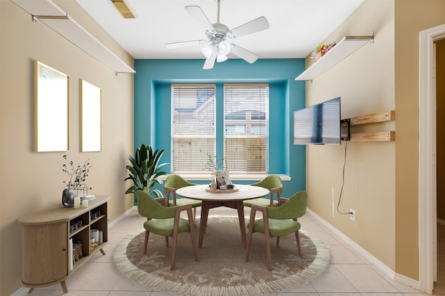 tiled dining room featuring ceiling fan