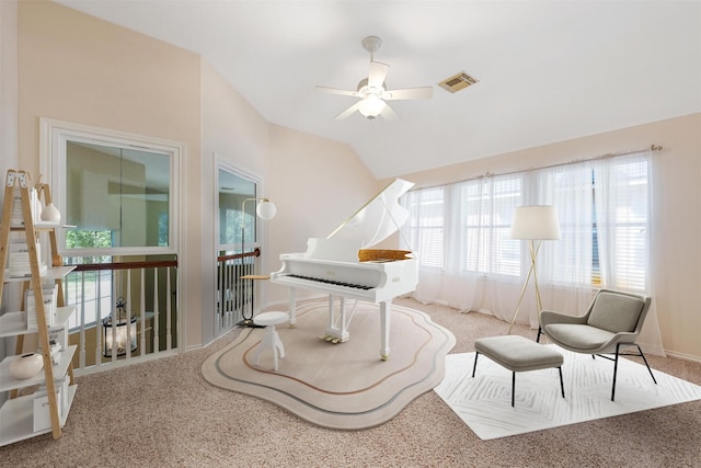 sitting room with ceiling fan, lofted ceiling, and light carpet