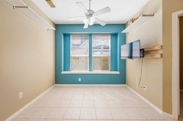 unfurnished dining area featuring light tile patterned flooring and ceiling fan