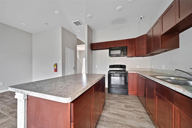 kitchen with a center island, sink, and black appliances