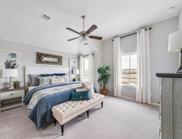 bedroom featuring light carpet, vaulted ceiling, and ceiling fan