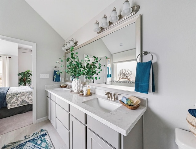 bathroom featuring tile patterned flooring, vanity, and lofted ceiling