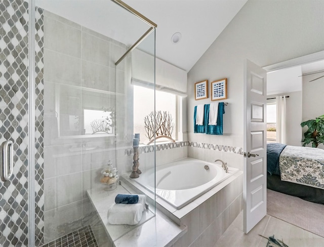 bathroom featuring vaulted ceiling, shower with separate bathtub, and tile patterned floors