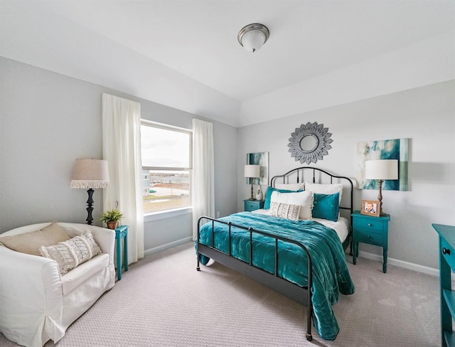 carpeted bedroom with lofted ceiling