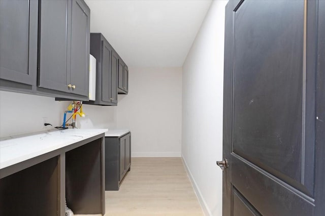 6609 Ave Q, Houston, TX 77011 - laundry area featuring light wood-style flooring and baseboards