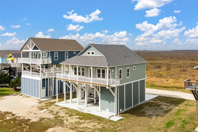 back of house featuring a patio and a balcony