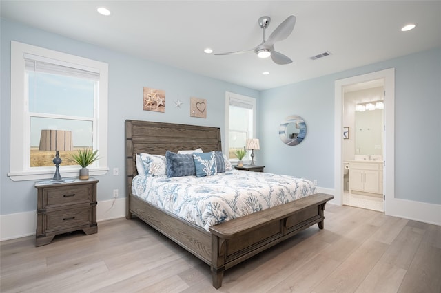 bedroom with ceiling fan, ensuite bathroom, and light hardwood / wood-style floors