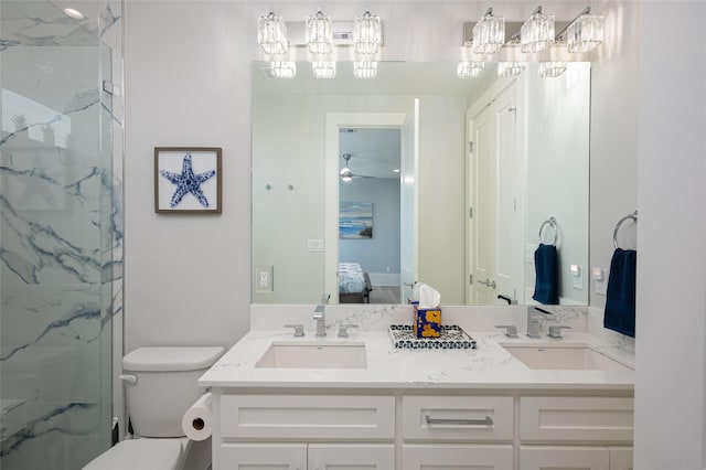 bathroom featuring vanity, walk in shower, ceiling fan, and toilet