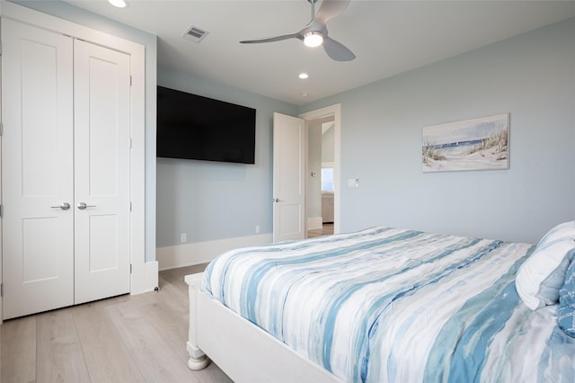 bedroom with light hardwood / wood-style flooring, a closet, and ceiling fan