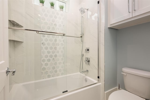 bathroom featuring shower / bath combination with glass door and toilet