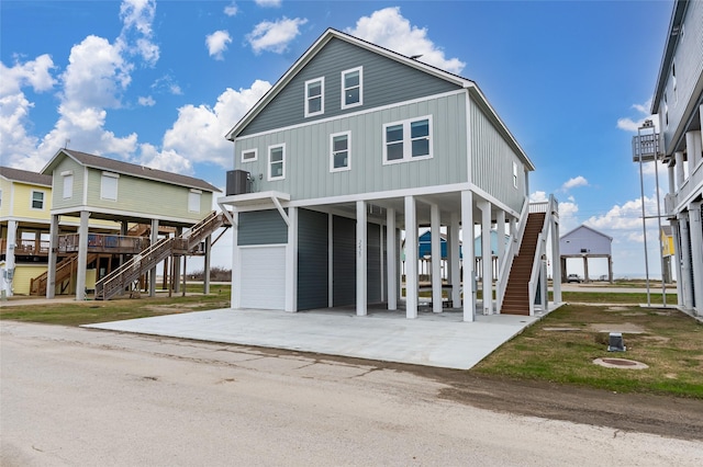 view of front of property featuring a carport and central AC