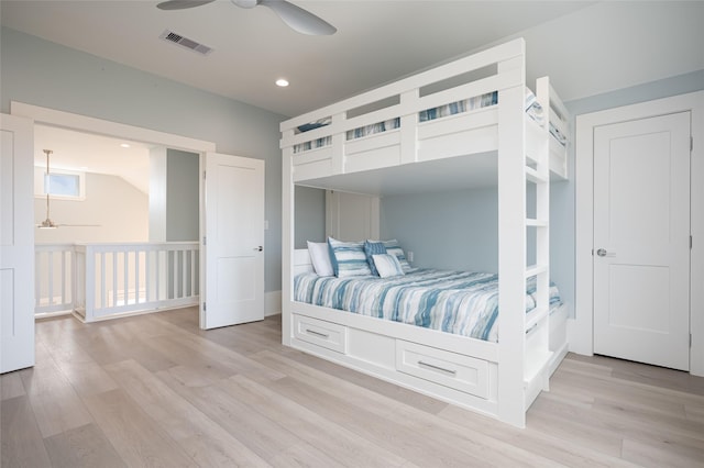 bedroom with light hardwood / wood-style floors and ceiling fan