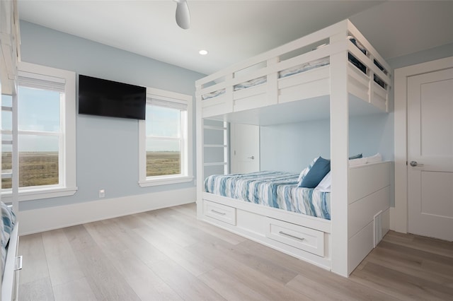 bedroom with light hardwood / wood-style floors and ceiling fan