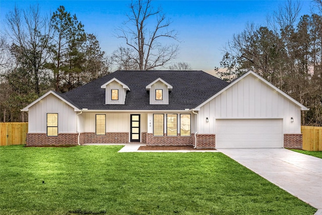 view of front facade with a garage and a lawn