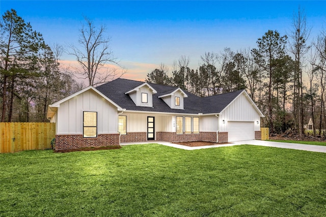 modern farmhouse featuring a garage and a lawn