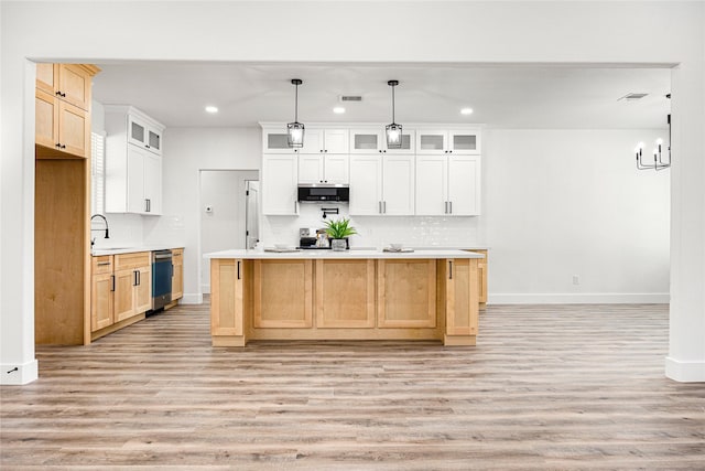 kitchen with an island with sink, appliances with stainless steel finishes, and white cabinets