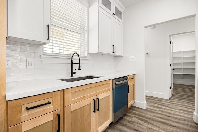 kitchen with sink, dishwasher, white cabinetry, tasteful backsplash, and dark hardwood / wood-style flooring