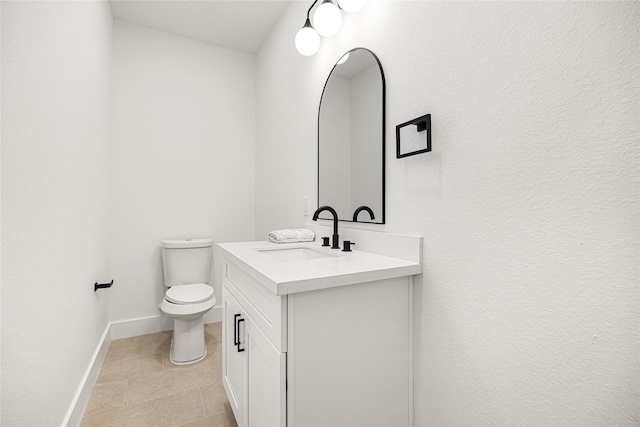 bathroom featuring vanity, tile patterned floors, and toilet