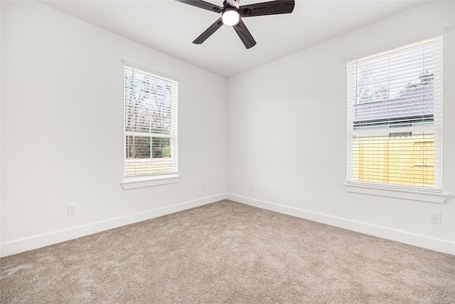 empty room featuring ceiling fan, a healthy amount of sunlight, and carpet flooring