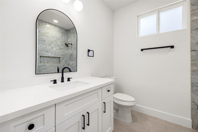 bathroom with vanity, walk in shower, tile patterned floors, and toilet