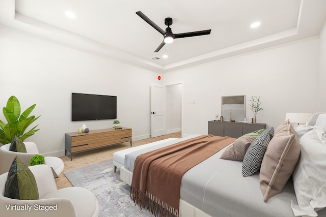 bedroom featuring ceiling fan and a raised ceiling